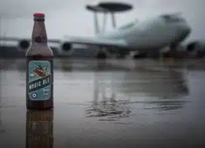 Bottle of beer in front of AWACS plane